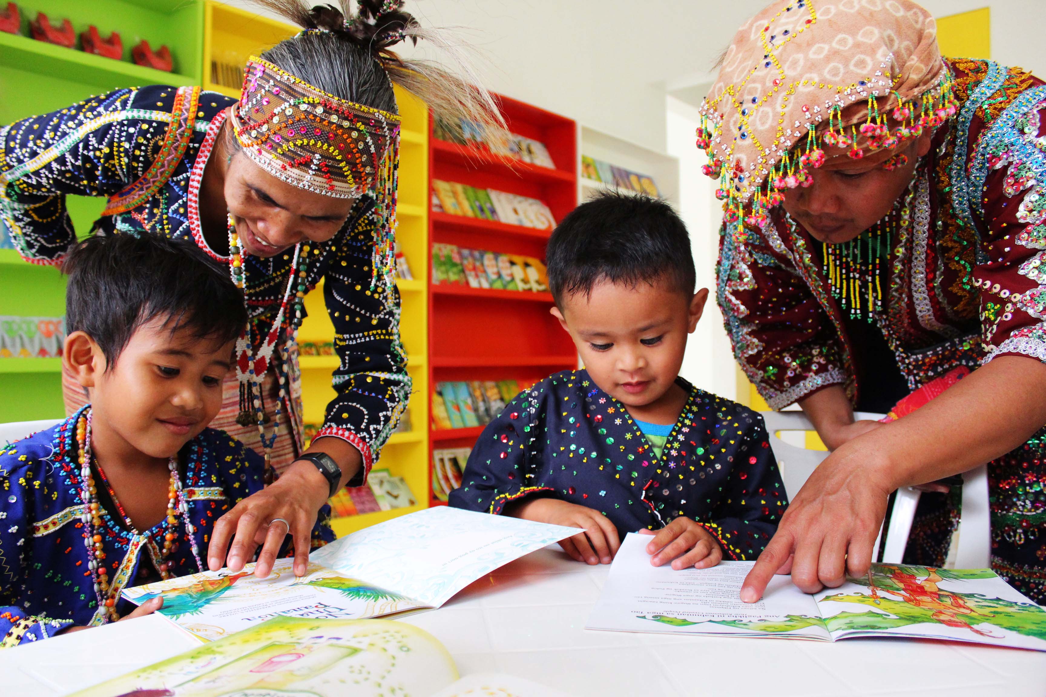 tribe in Sibulan City Side, Davao del Sur, assist their children in reading books. The parents also enjoy looking at the colorful illustrations on the storybooks.
