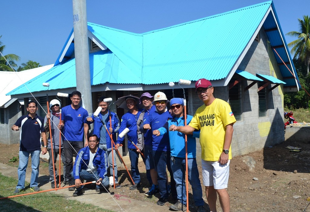 Davao Light and Power Co. EVP and COO Arturo M. Milan (rightmost) leads the Bayanihan Painting Day on February 6, 2016 at the newest Sweet Home Alabama- Gawad Kalinga Village located at the Relocation Area, Los Amigos, Tugbok, Davao City. Also in photo are (from left to right) Community Relations Manager Fermin Edillon, Panabo Branch