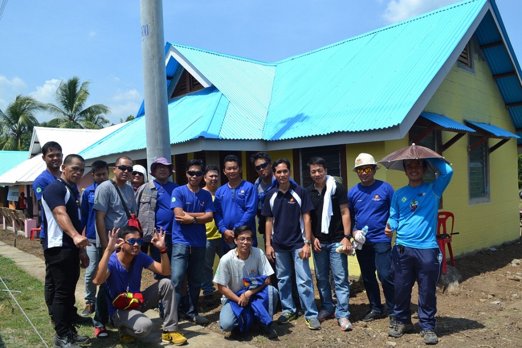 The 20 volunteer-employees of the Davao Light and Power Co. pose after the successful Bayanihan Painting Day at the Sweet Home Alabama- Gawad Kalinga Village located at the Relocation Area, Los Amigos, Tugbok, Davao City on February 6, 2016.