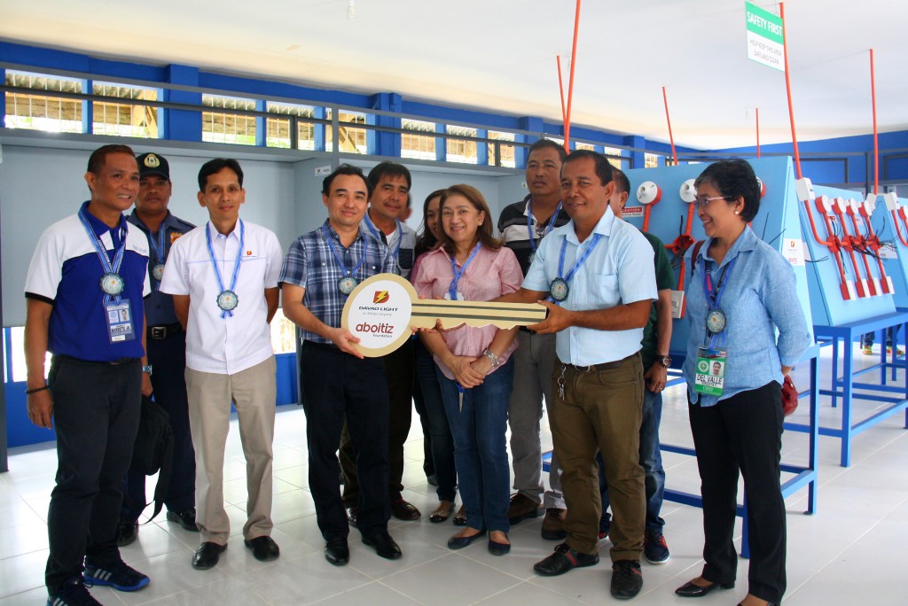 Malabog National High School Principal Randy B. Alonzo (2nd from right) receives the symbolic key from Davao Light and Power Co. Panabo Branch Manager and AVP Engr. Ronald Chan (3rd from left) last February 26, 2016 inside the electrical laboratory facility in Malabog National High School. Also in photo are Davao Light