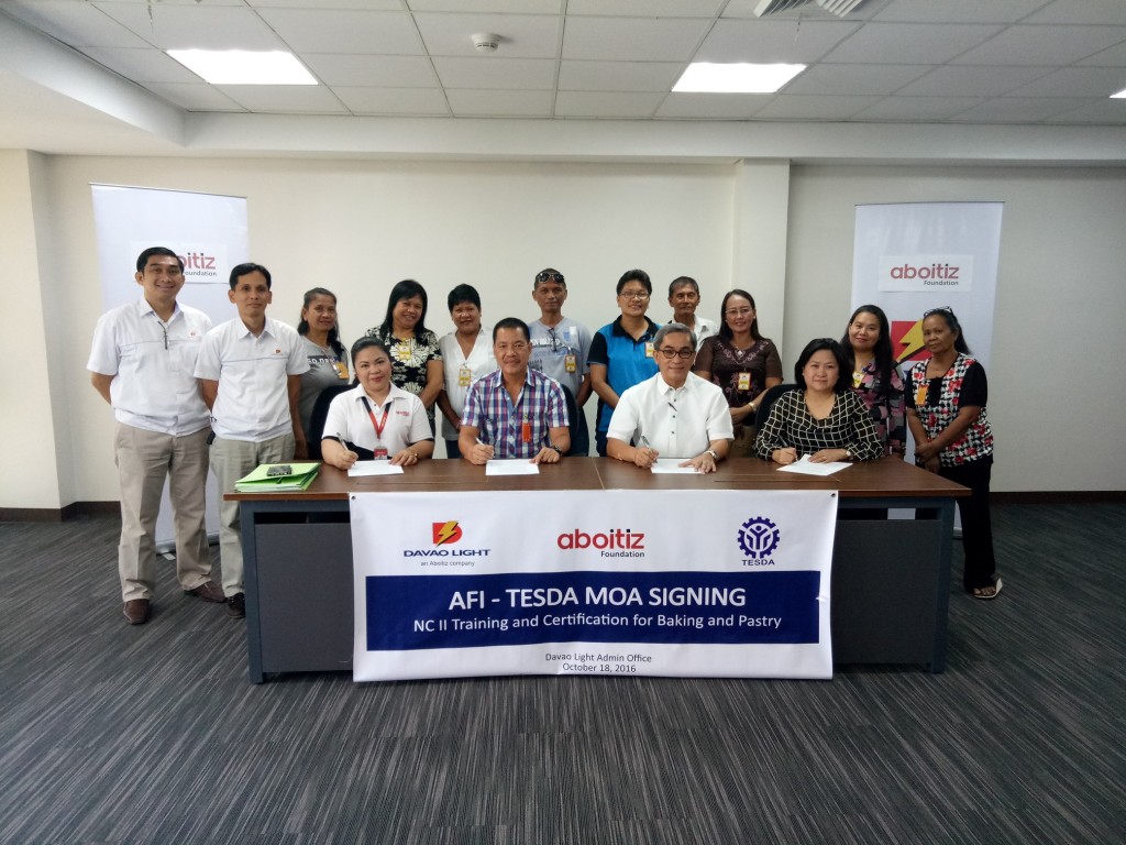 In photo (seated from left to right) are Jennifer Sabianan (Enterprise Development & Microfinance Manager of Aboitiz Foundation), Engr. Nestor Tabada (Provincial Director of TESDA), Arturo M. Milan (COO & EVP of Davao Light and Power Co., Inc.), and Joan Reyes of Philippine Baking Institute. Also in photo are the Davao Light team leaders and the beneficiaries from DESEMULCO, ADAP, and SAMPCO. 