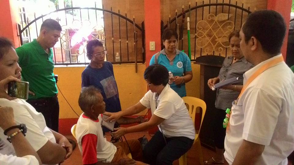 Barangay Ilayang Polo health worker checks the blood pressure of the senior citizen during the turnover of the health and emergency response equipment. The donated equipment aim to uplift the health & well-being of the host communities of Therma Luzon, Inc in Pagbilao, Quezon.