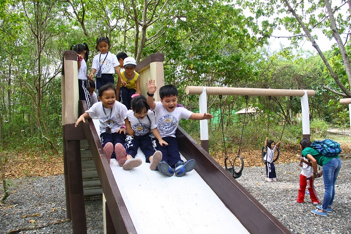 The SMILE Learners are experiencing the fun and excitement of the playground in the Cleanergy Park after the mangrove planting and educational tour activity.